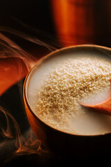 Couscous in a wooden bowl with steam rising in a warm kitchen setting