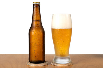 Bottle of beer and glass with foam on a table, close-up, cold drink