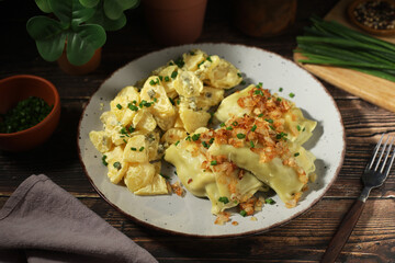 Traditional Swabian dish Maultaschen served with roasted onion and potato salad