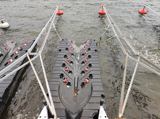 A pontoon, a floating craft in gray water