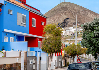 Gáldar, Gran Canaria – Residential street with colorful facades and impressive volcanic mountain. Colorful urban design in a Canary residential area