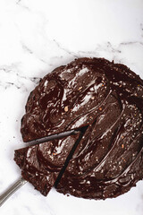 chocolate cake, round cake, on a marble light table, top view, homemade cakes, no people,