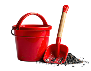 Red plastic children's sand pail and shovel set, on dark sand pile