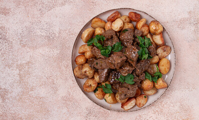 kuyrdak, roast offal with potatoes and fresh herbs, homemade in Kazakh, no people,