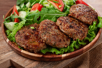 Fried cutlets, mixed minced meat, with vegetable salad, homemade, top view, no people,