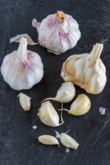 Garlic bulbs on dark slate background