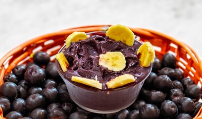 The most authentic Brazilian açaí, Euterpe oleracea, with banana in a minimalist bowl and compatible environment. Superfood energy and vitamins