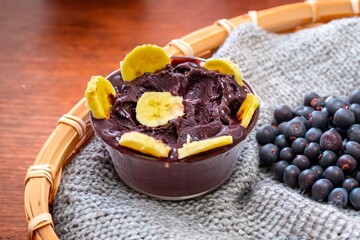 The most authentic Brazilian açaí, Euterpe oleracea, with banana in a minimalist bowl and compatible environment. Superfood energy and vitamins