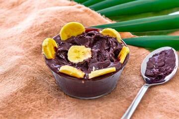 The most authentic Brazilian açaí, Euterpe oleracea, with banana in a minimalist bowl and compatible environment. Superfood energy and vitamins