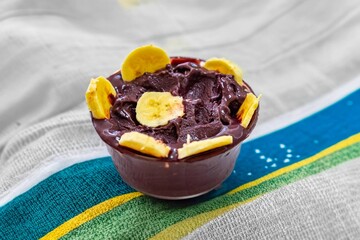 The most authentic Brazilian açaí, Euterpe oleracea, with banana in a minimalist bowl and compatible environment. Superfood energy and vitamins