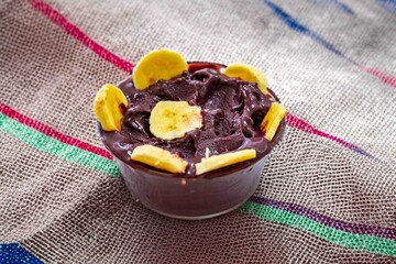 The most authentic Brazilian açaí, Euterpe oleracea, with banana in a minimalist bowl and compatible environment. Superfood energy and vitamins