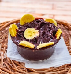 The most authentic Brazilian açaí, Euterpe oleracea, with banana in a minimalist bowl and compatible environment. Superfood energy and vitamins