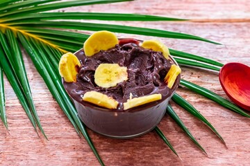 The most authentic Brazilian açaí, Euterpe oleracea, with banana in a minimalist bowl and compatible environment. Superfood energy and vitamins