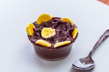 The most authentic Brazilian açaí, Euterpe oleracea, with banana in a minimalist bowl and compatible environment. Superfood energy and vitamins