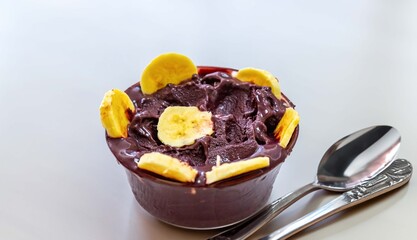 The most authentic Brazilian açaí, Euterpe oleracea, with banana in a minimalist bowl and compatible environment. Superfood energy and vitamins