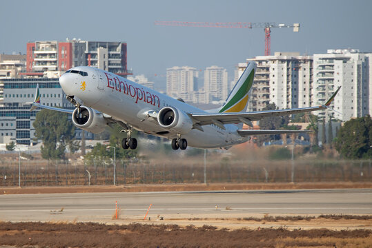 Ben Gurion Airport, Israel &ndash; 2025.09.27: Ethiopian Airlines Boeing 737 MAX 8 ET-AZO taking off with city skyline in background