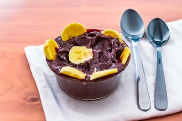 The most authentic Brazilian açaí, Euterpe oleracea, with banana in a minimalist bowl and compatible environment. Superfood energy and vitamins