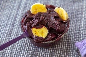 The most authentic Brazilian açaí, Euterpe oleracea, with banana in a minimalist bowl and compatible environment. Superfood energy and vitamins