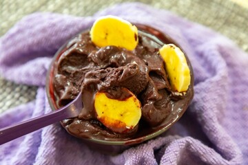 The most authentic Brazilian açaí, Euterpe oleracea, with banana in a minimalist bowl and compatible environment. Superfood energy and vitamins