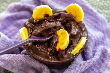 The most authentic Brazilian açaí, Euterpe oleracea, with banana in a minimalist bowl and compatible environment. Superfood energy and vitamins
