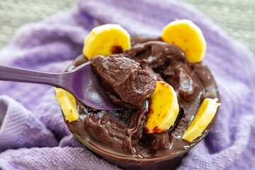 The most authentic Brazilian açaí, Euterpe oleracea, with banana in a minimalist bowl and compatible environment. Superfood energy and vitamins