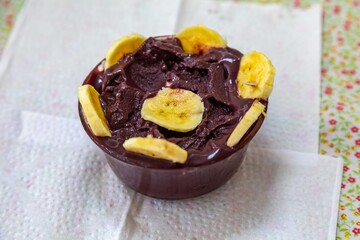 The most authentic Brazilian açaí, Euterpe oleracea, with banana in a minimalist bowl and compatible environment. Superfood energy and vitamins