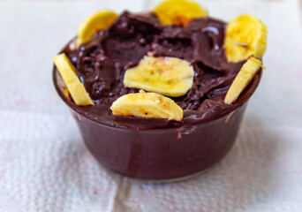 The most authentic Brazilian açaí, Euterpe oleracea, with banana in a minimalist bowl and compatible environment. Superfood energy and vitamins