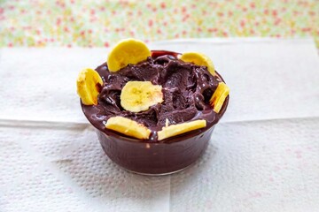 The most authentic Brazilian açaí, Euterpe oleracea, with banana in a minimalist bowl and compatible environment. Superfood energy and vitamins