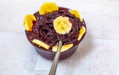 The most authentic Brazilian açaí, Euterpe oleracea, with banana in a minimalist bowl and compatible environment. Superfood energy and vitamins