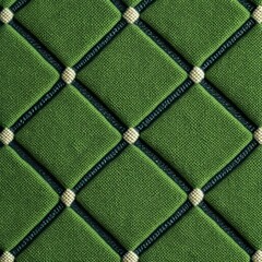 Naklejka premium Elegant green quilted fabric with diamond pattern creates a luxurious texture for backgrounds, upholstery, and fashion design projects - sophisticated and versatile