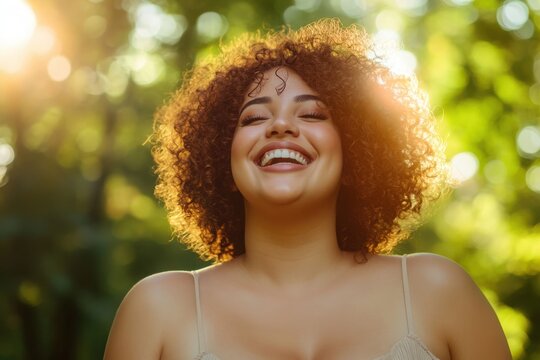 A confident plus size woman with curly hair smiling brightly in a sunlit park - Powered by Adobe