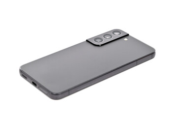 A black cell phone is laying on a white background