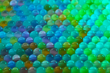 A close up of many different colored glass beads