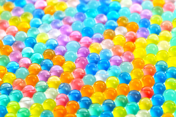 A colorful array of small, clear, and shiny spheres