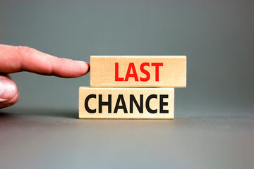 Last chance symbol. Concept word Last chance on beautiful wooden blocks. Beautiful grey paper...