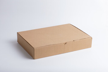 Side view flat cardboard box mockup on white. Kraft paper packaging for e-commerce, shipping, food delivery, eco-friendly design, recyclable and minimal container.
