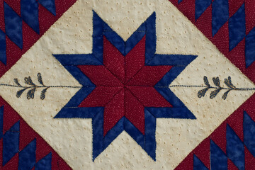 Red blue and beige geometric quilt pattern