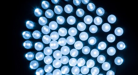 Brilliant array of glowing blue lights creates a mesmerizing pattern on a sleek black background illuminating technology and innovation projects