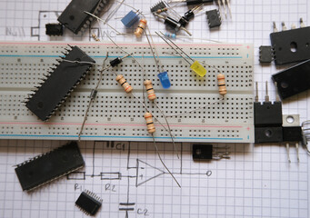 Electronic components in laboratory. Analog integrated circuits, resistors, LEDs on a breadboard. 