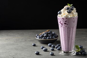 blueberry milkshake with whipped cream and berries, dark minimal background with text space