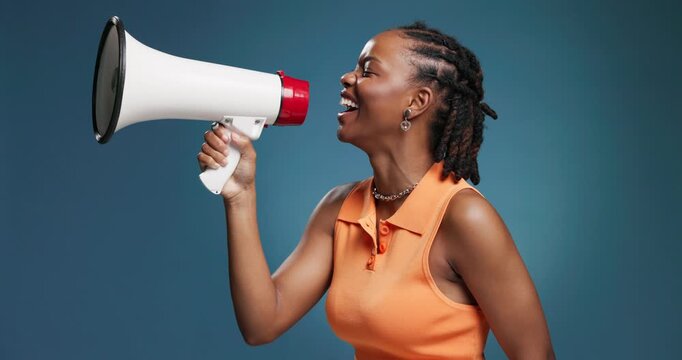 Megaphone, shouting and black woman in studio with news for announcement, information and speech. Happy, space and person with bullhorn for notification, sales and promotion on blue background