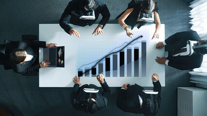 A dynamic business team engages in innovative data analysis using virtual reality headsets in a sleek office setting, focusing on growth strategies and insights. Axiom
