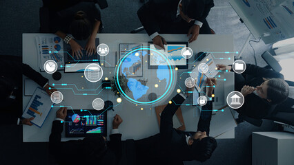 A diverse business team collaborates in a modern office, engaging in digital project discussions while using technology for data visualization and strategic analysis. Trope