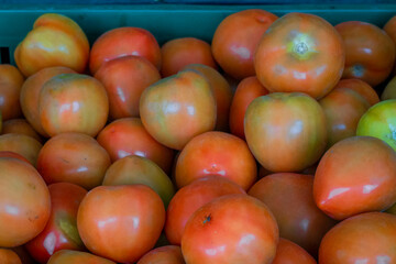 Tomatoes lying in a pile on top of each other, tomato texture.