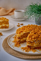 Carrot cake on a white plate on a white table