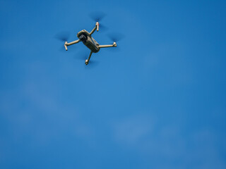 Flying Drone with Blurred Propellers in Sky View
