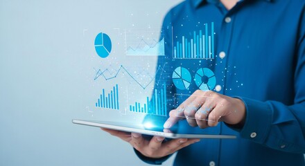 A person in a blue shirt holding a tablet displaying various types of data charts and graphs overlayed