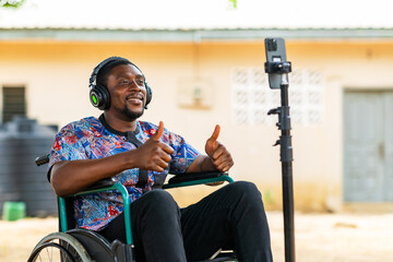 African Man in Wheelchair Using Smartphone for Video Call