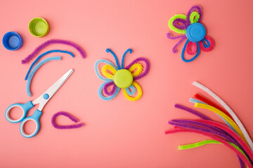 Butterflies made of colorful pipe cleaners and plastic bottle caps, DIY craft for kids, recycling project, creative activity, handmade idea for school, workshop, education, eco learning,