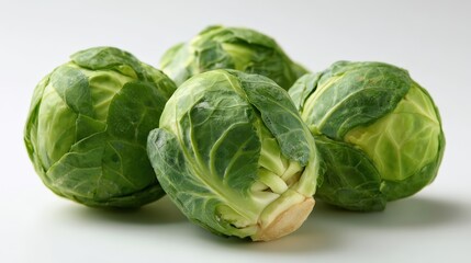 Fresh green brussels sprouts arranged on white background for culinary focus